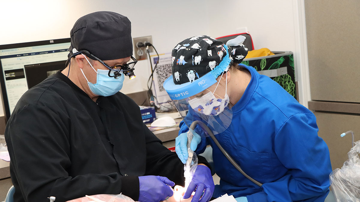 An instructor and a student at the San Juan College Dental Clinic.