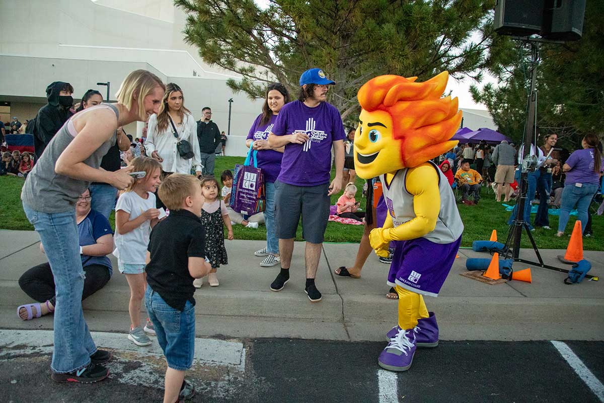 Community members meeting Mascot Blaze at San Juan College Balloon Glow.