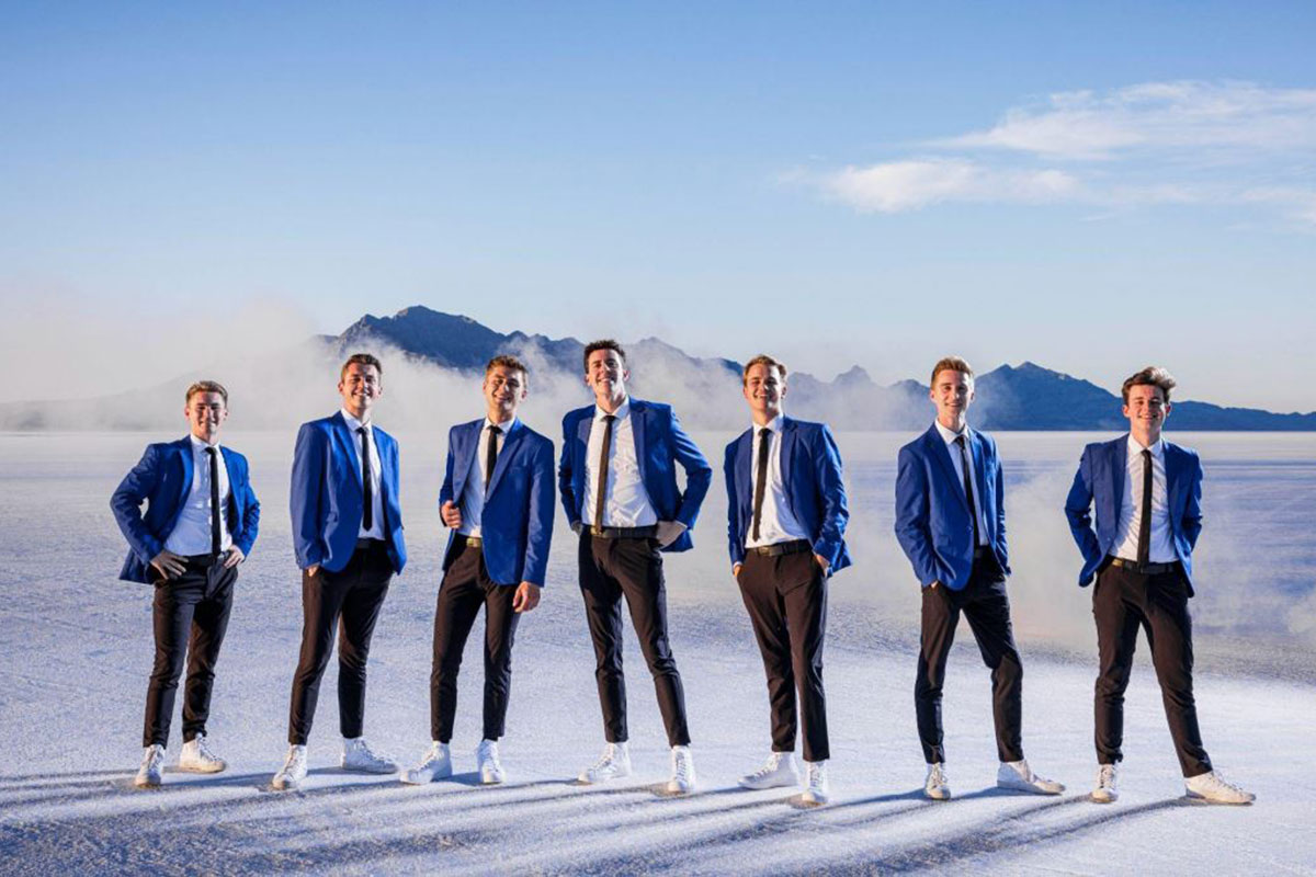 Group of gentlemen standing in blue jackets from the BYU Vocal Group.