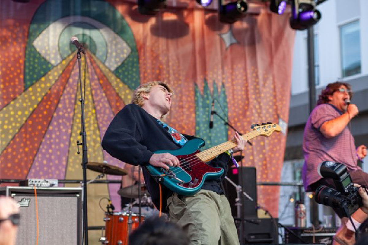 Member of the Backhand band playing his guitar