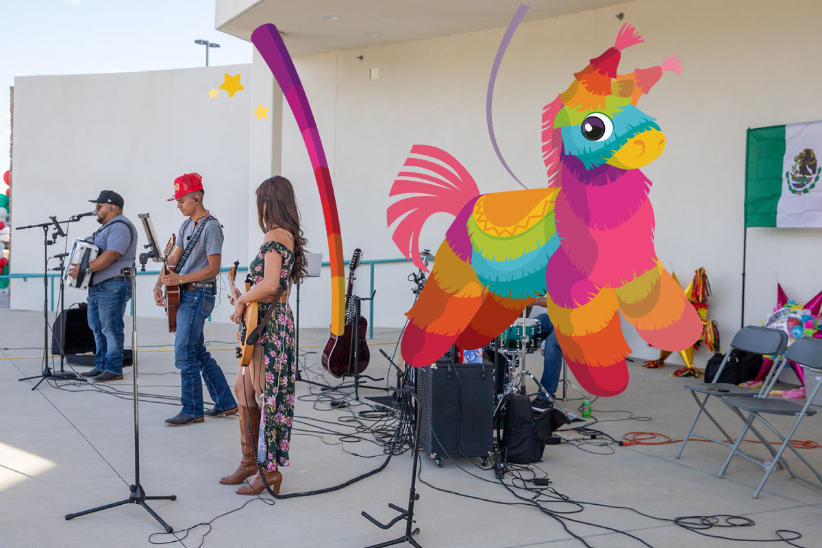 A band playing on the SJC Graduation Plaza stage with a colorful pinata to the right