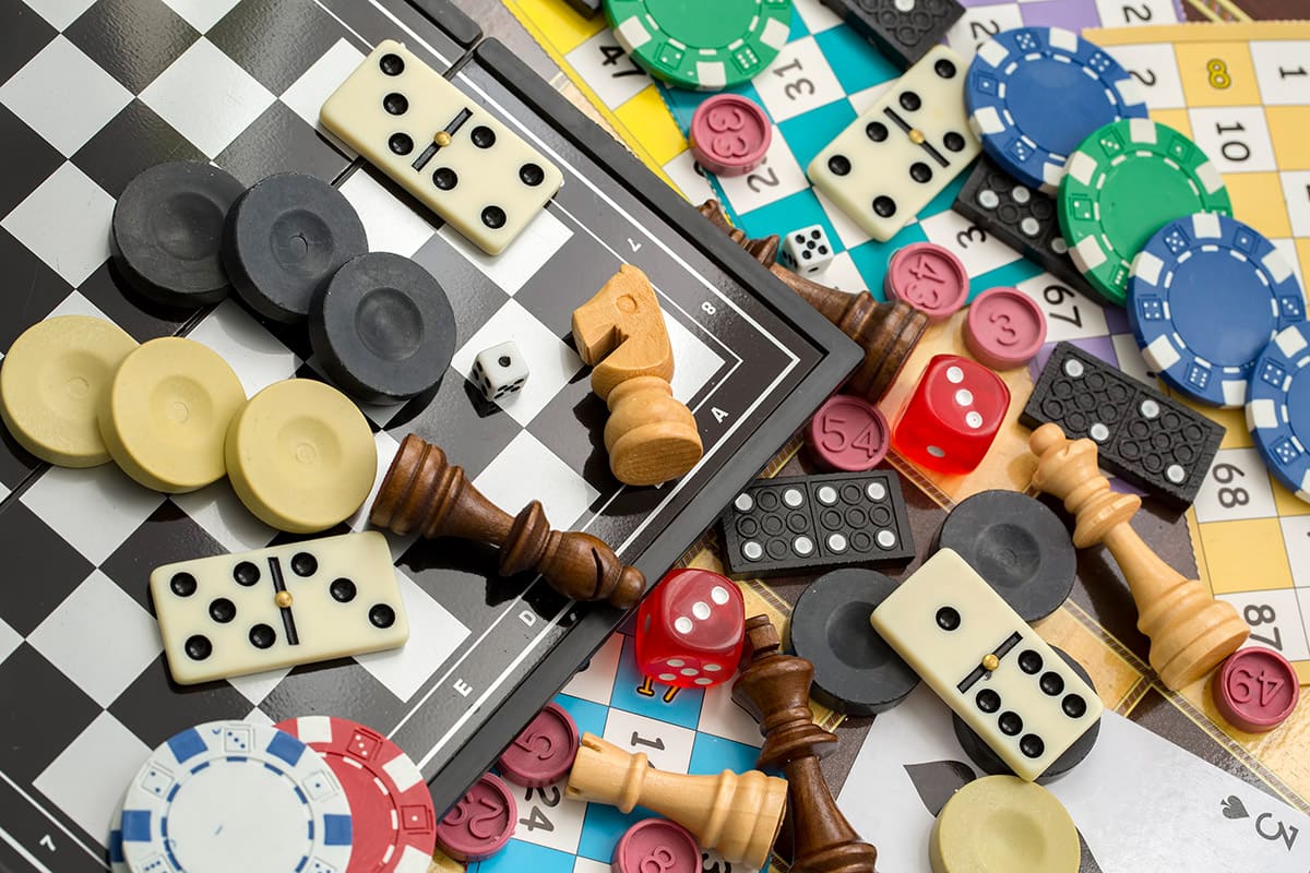 A collection of game boards and pieces for Chess, Dominoes and Bingo