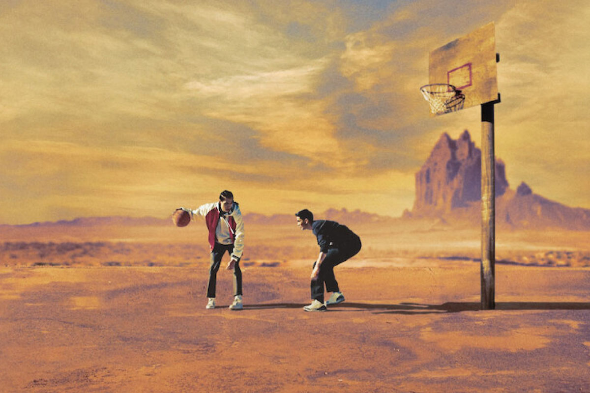 Two men playing basketball on the Rez