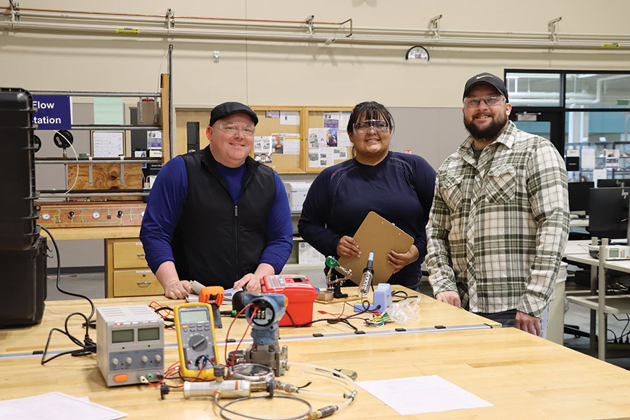 Three School of Energy interns sitting at a table