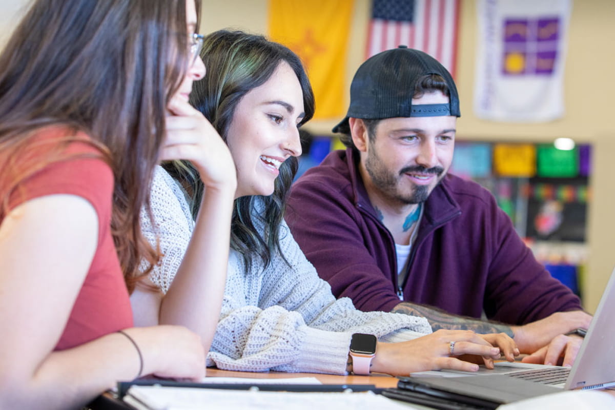 Students working together in front of computer