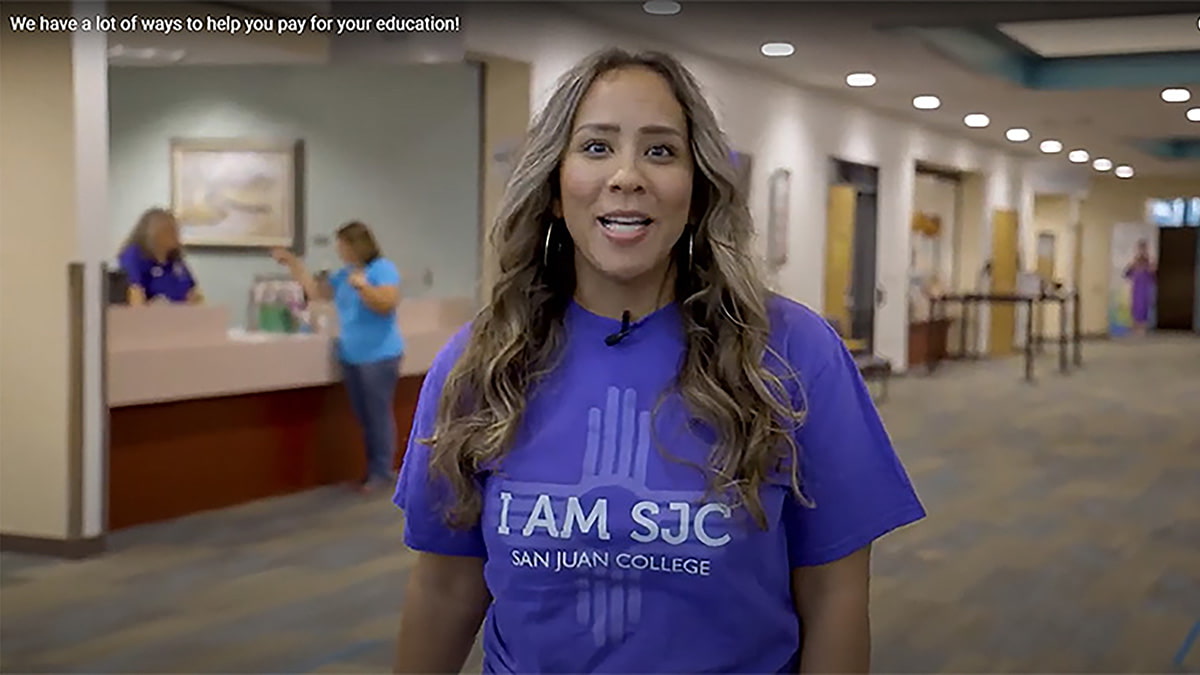 San Juan College student in front of the Financial Aid office