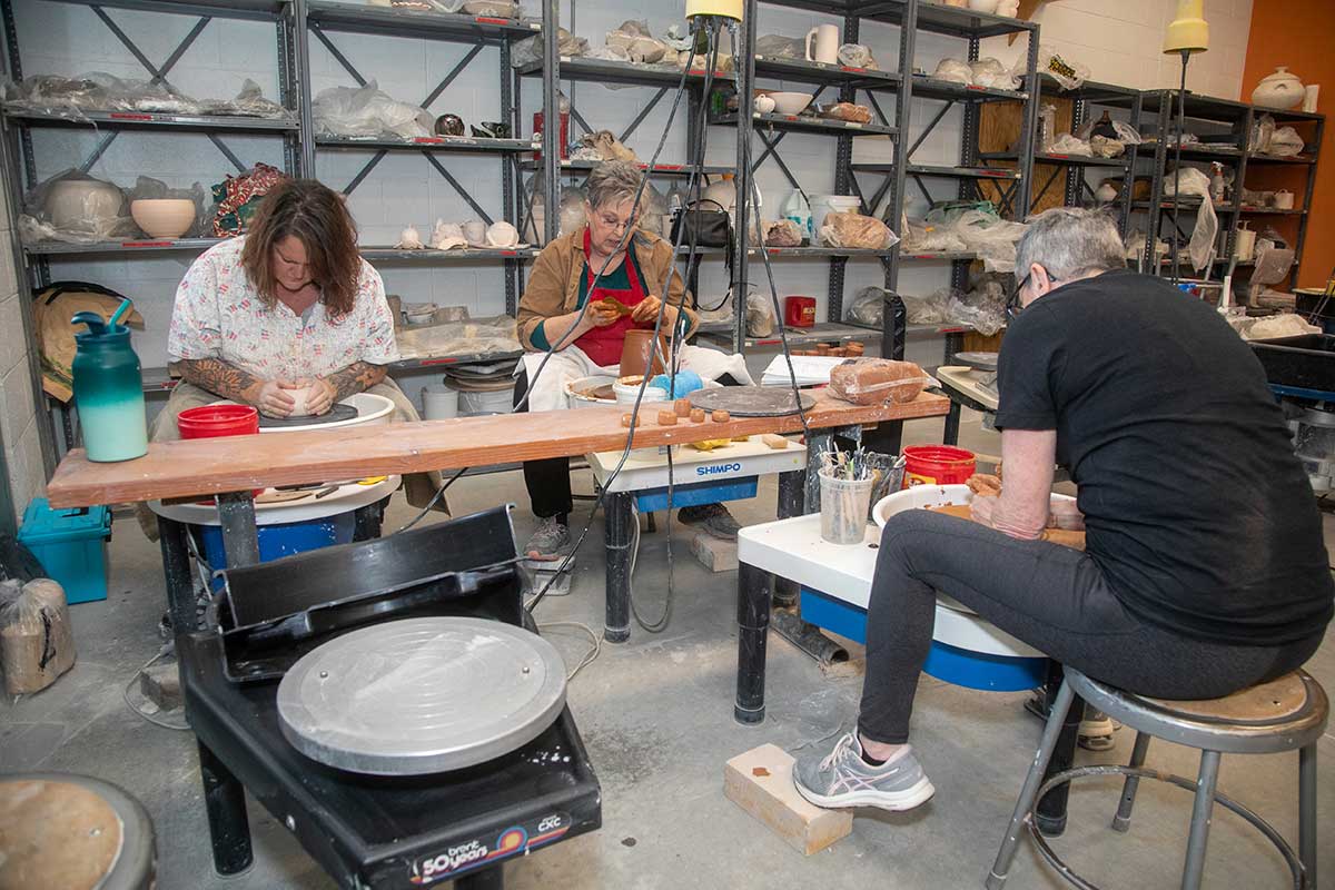 SJC students in a pottery class.