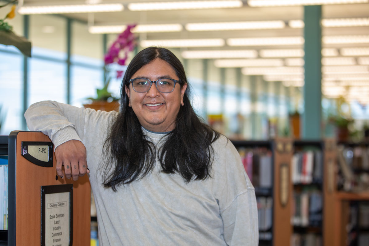 San Juan College student standing in SJC Library