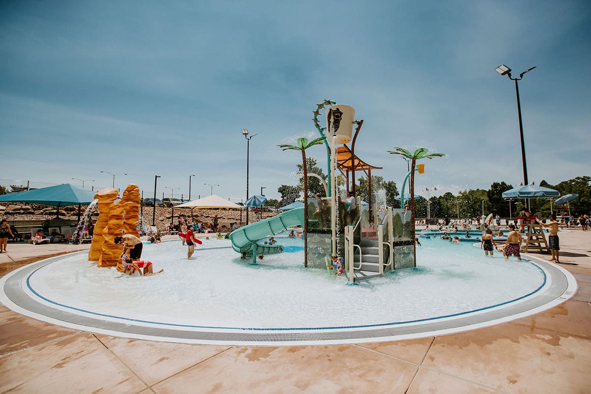 family splash around in the wading pools and waterfalls at Bisti Bay Waterpark in Farmington.