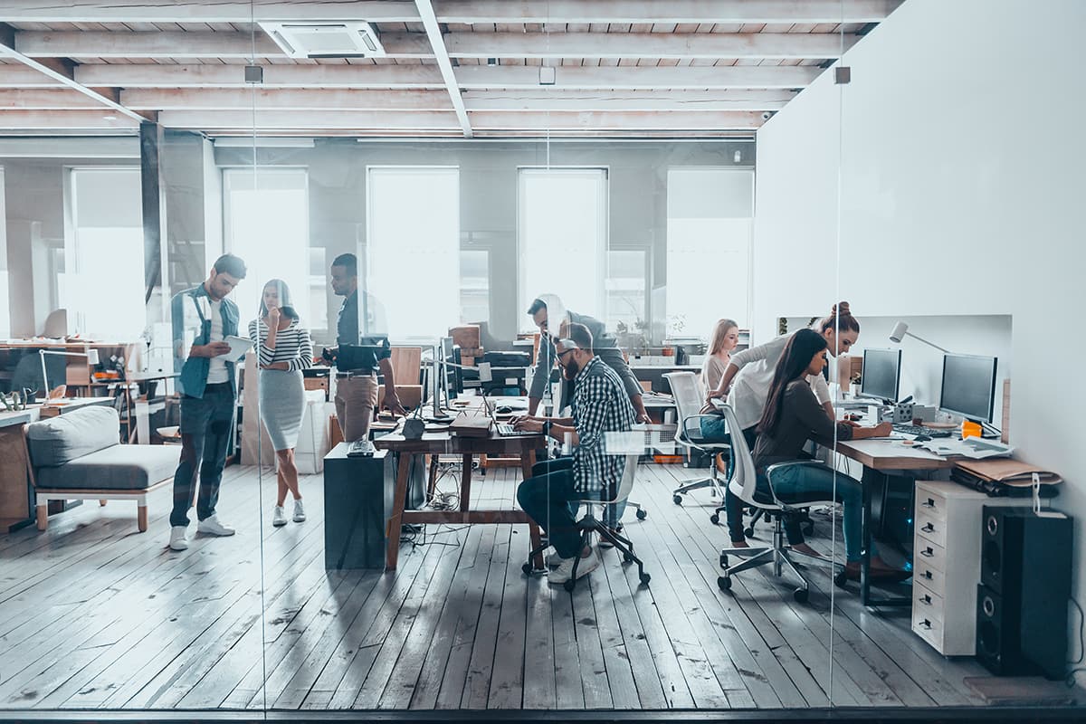 Group of young business people in smart casual wear working together in creative office.