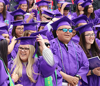 Students in cap and gown at graduation.