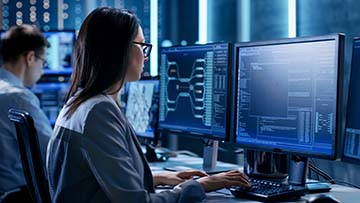 Two people looking at computer screens