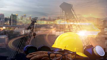 Hardhat with construction in the background.