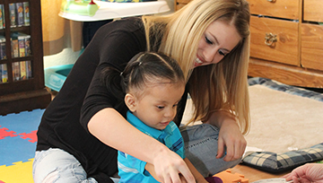 Child sitting in person's lap