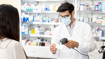 Pharmacist scanning a prescription.