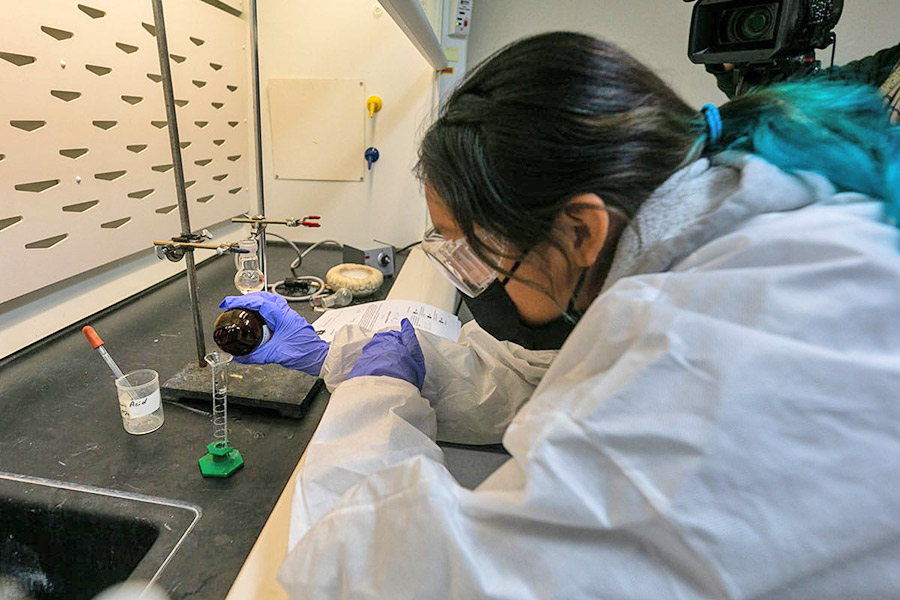 Student works with fluids and test tubes in chemistry class