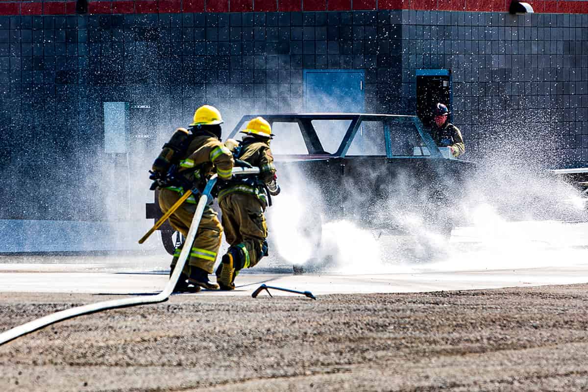 Students in the Fire Science Program putting out a fire