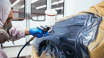 Car being spray painted.