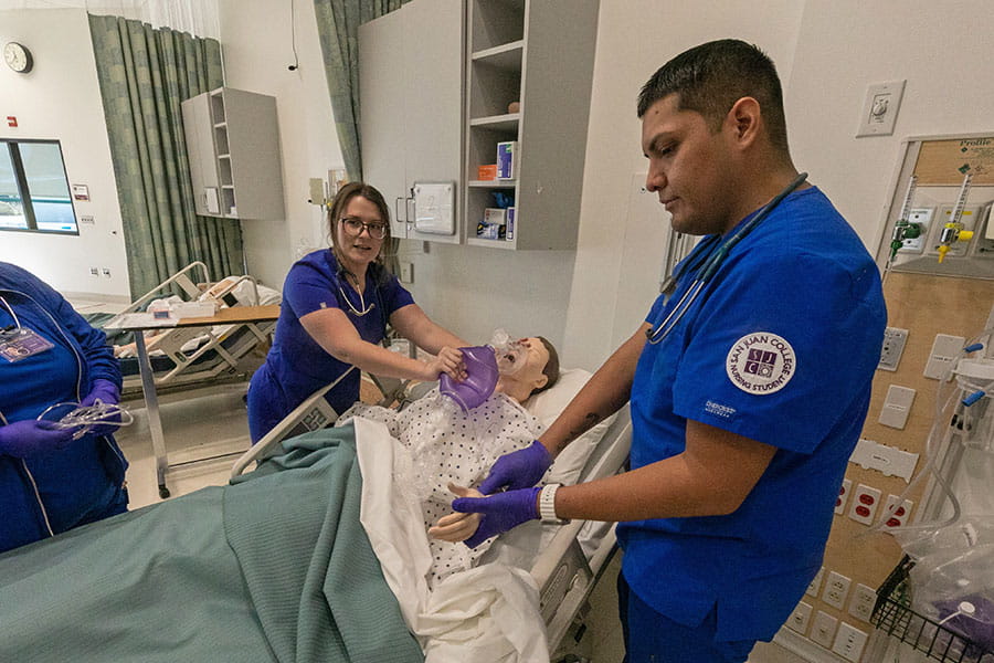 Two students in the simulator lab working towards their Nursing BSN Degree at SJC!