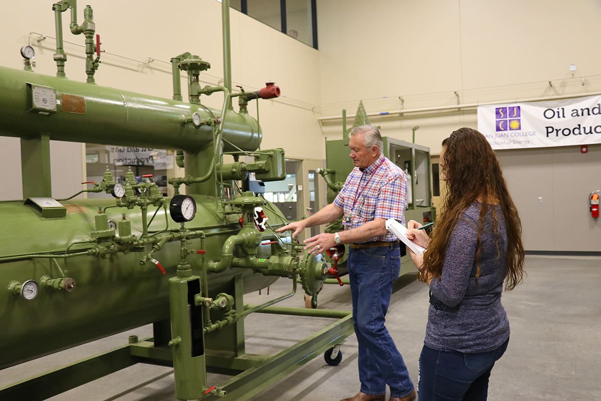 Instructor goes over program equipment with student explaining the processes of the large separator.