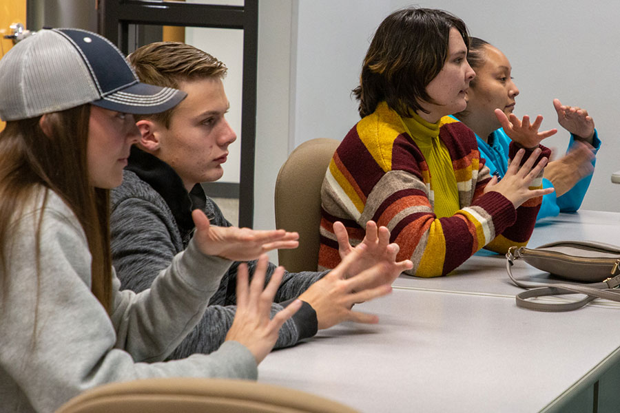 San Juan College students practicing American Sign Language hand signs in class