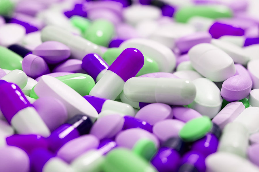 Close up image of purple, white and green colored pills