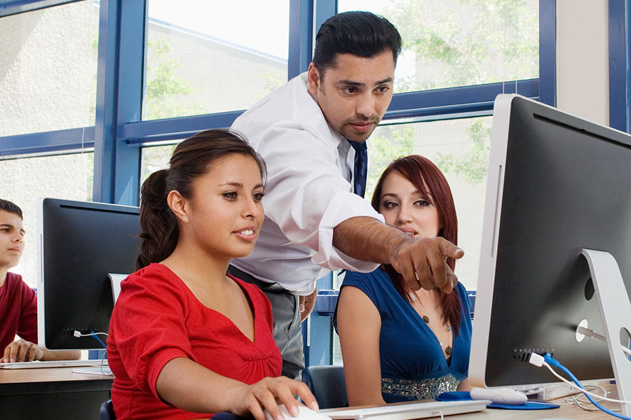 An instructor working with Teacher Education students