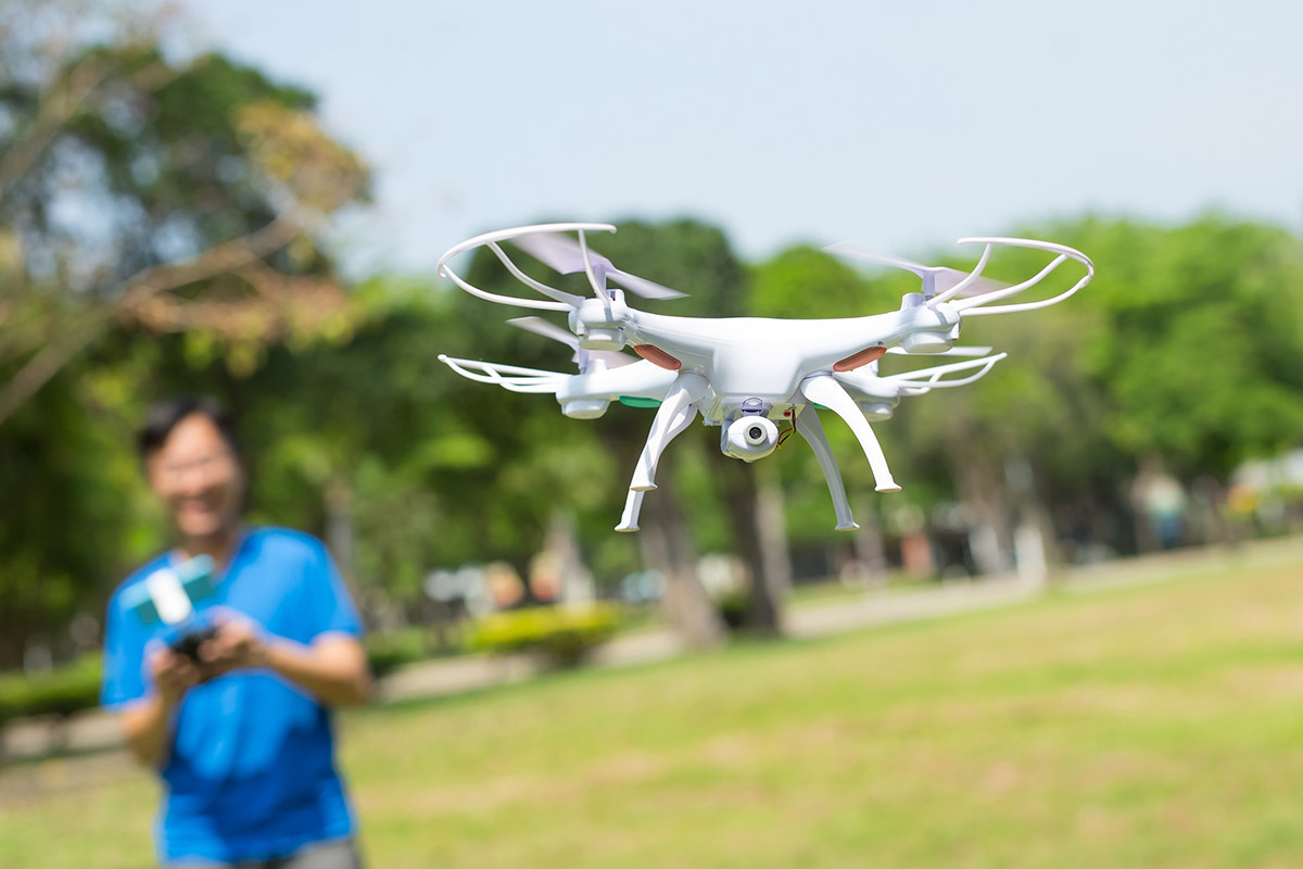 student flying drone