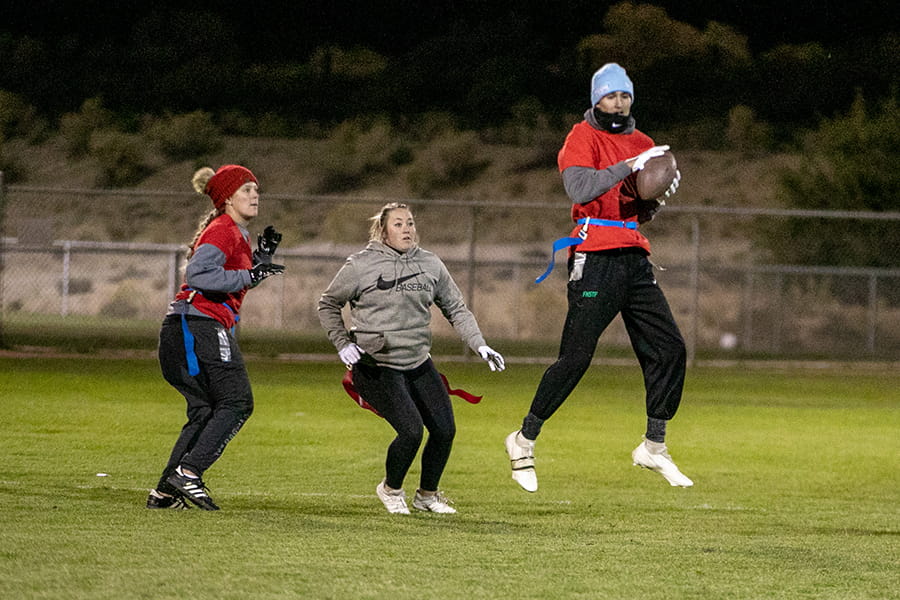 Three students playing football