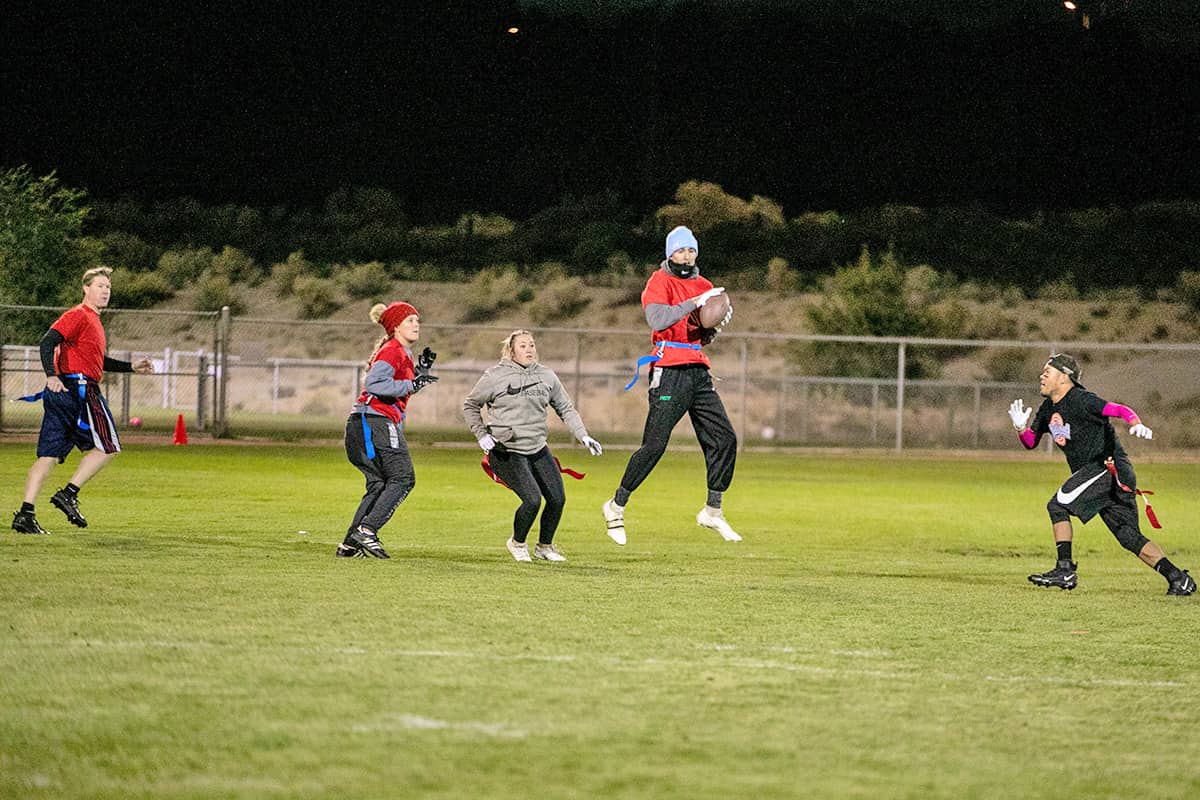 flag football game as receiver catches a pass