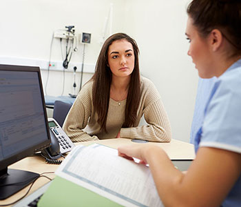 Student talking with medical provider in a clinic setting