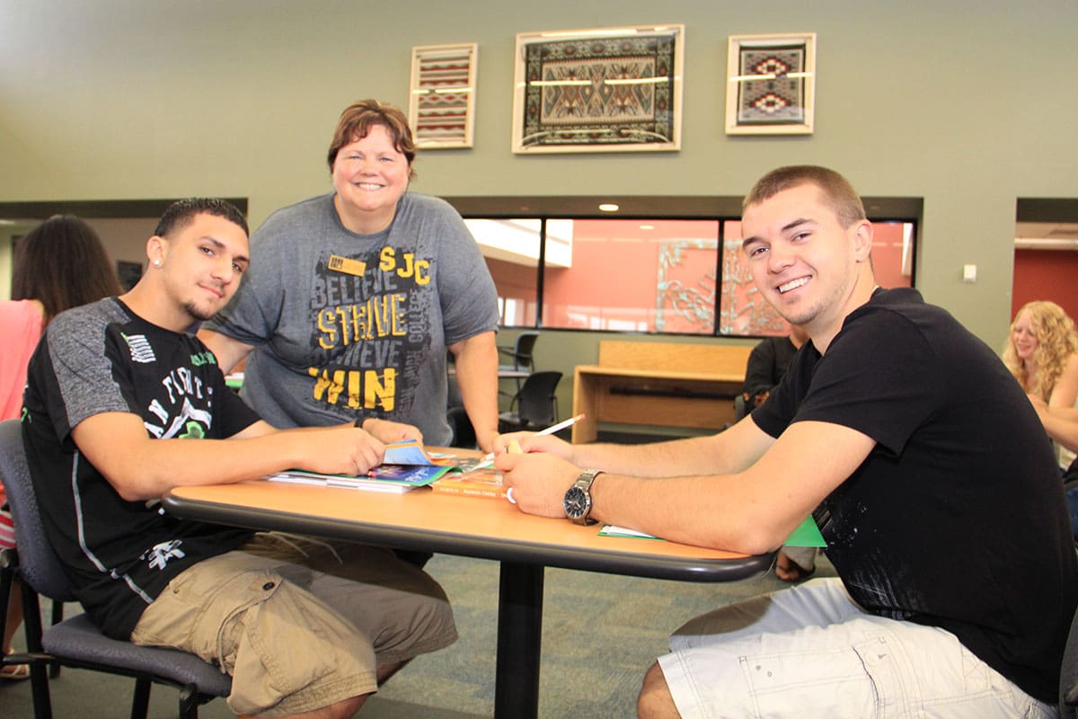 SJC students sitting at a table.