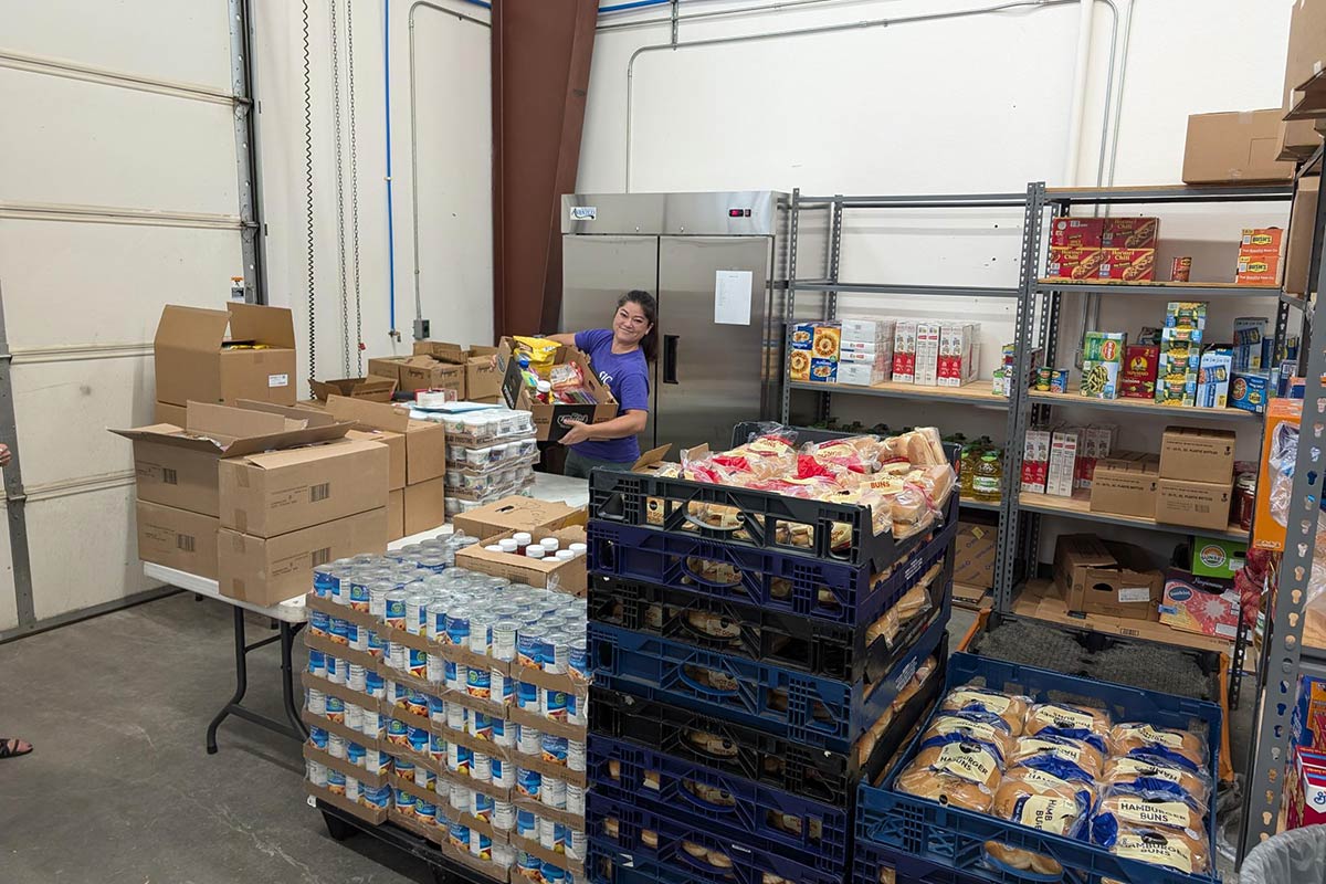 Food for Thought staff member preparing Food in Box for San Juan College Students.