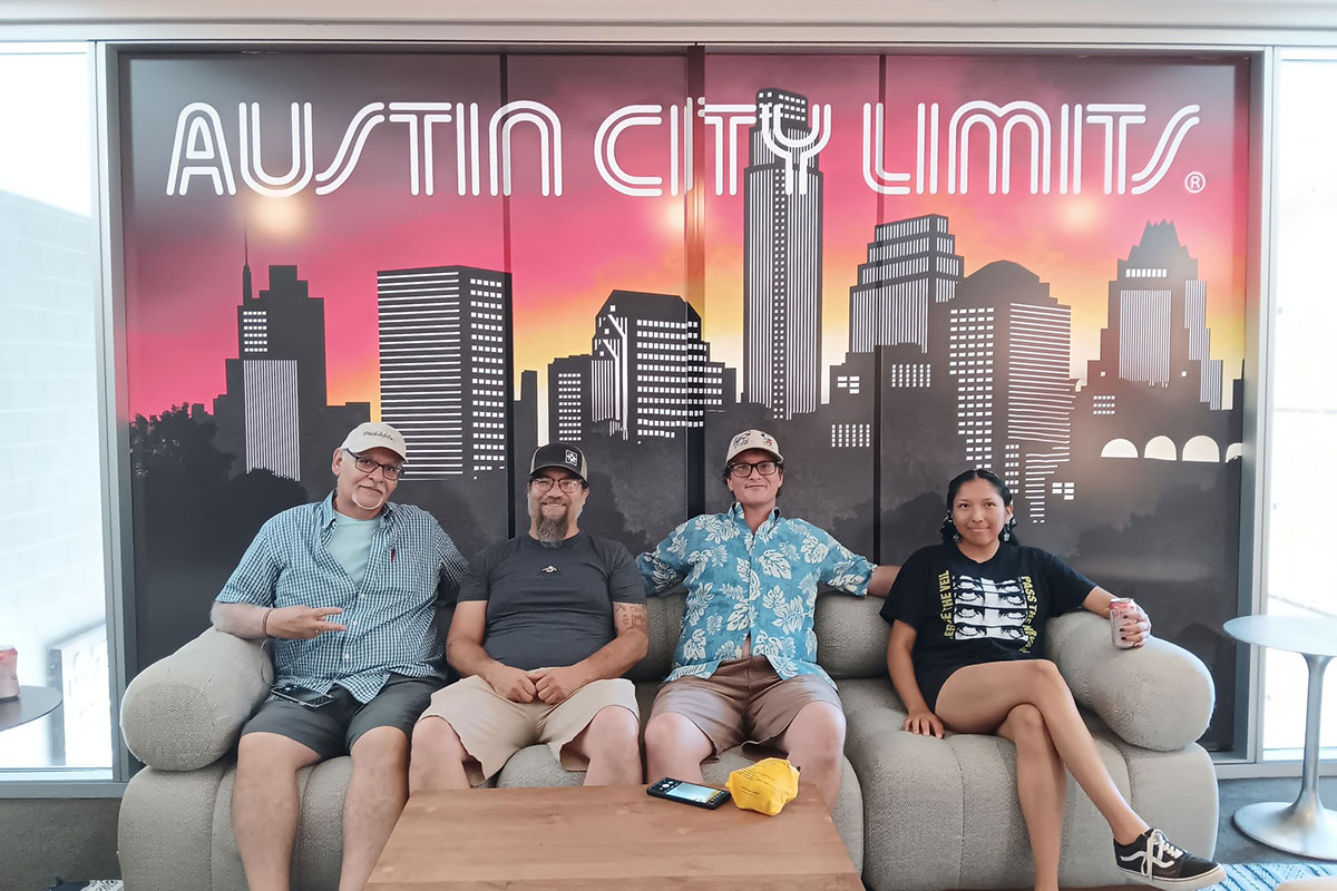 Group of TRIO Students on a couch with a Austin City Limits sign behind them.