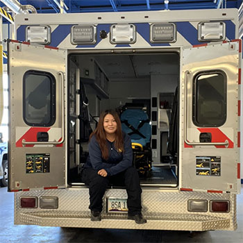 Tashawnee Wood sits in the back of an ambulance.