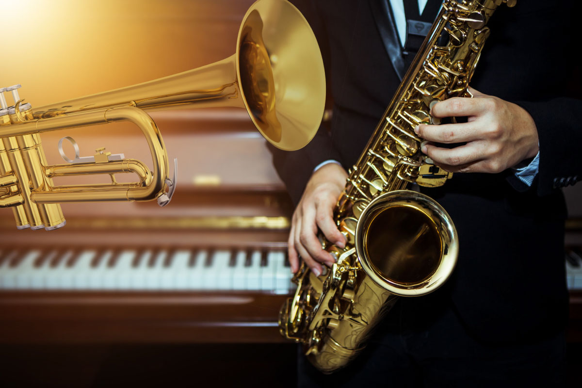 A trumpet, a piano and a gentleman in a suit playing a saxophone