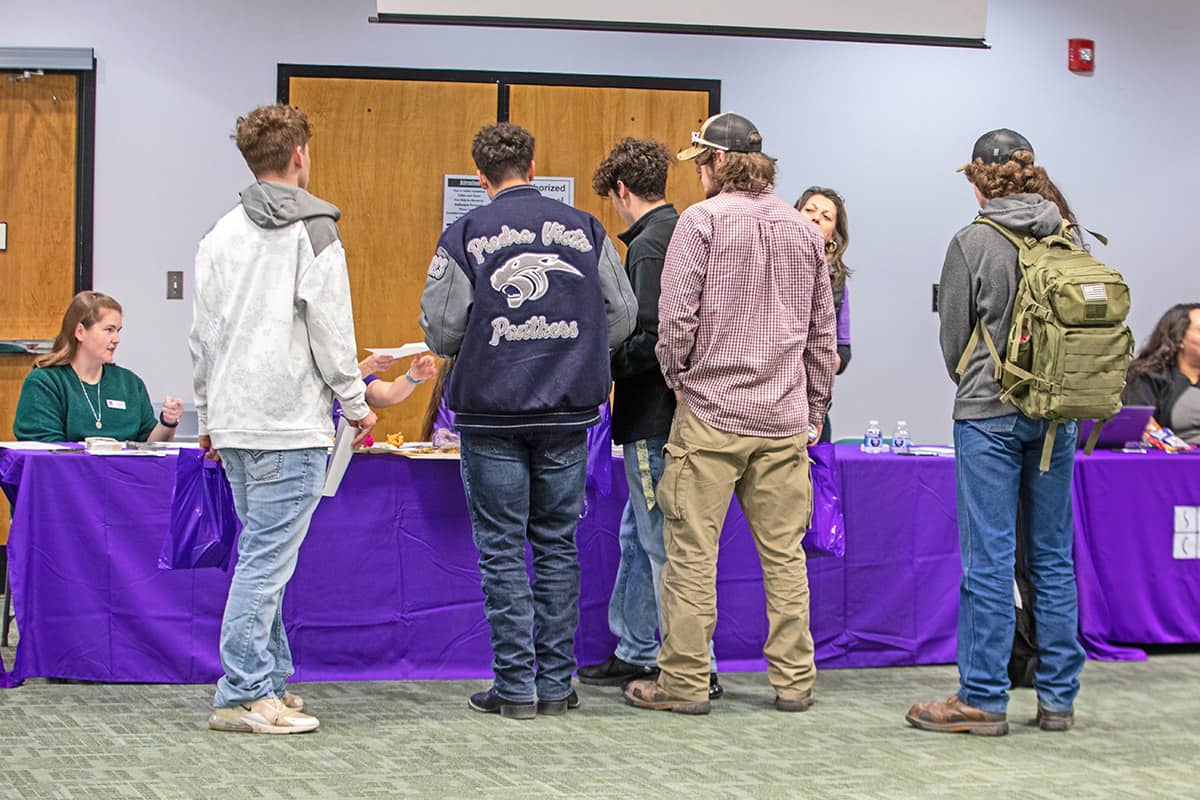 High school students get some information from one of the info tables at orientation.