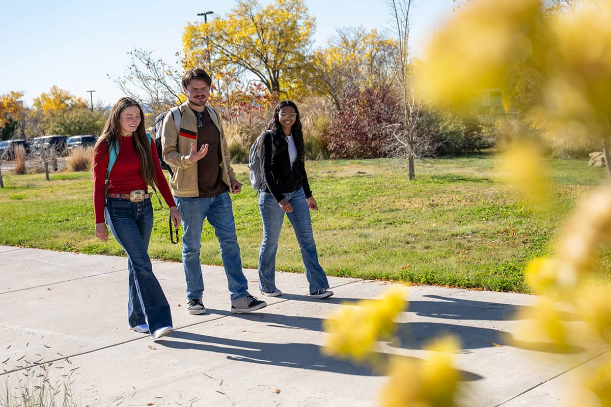 Three SJC students walking on main campus
