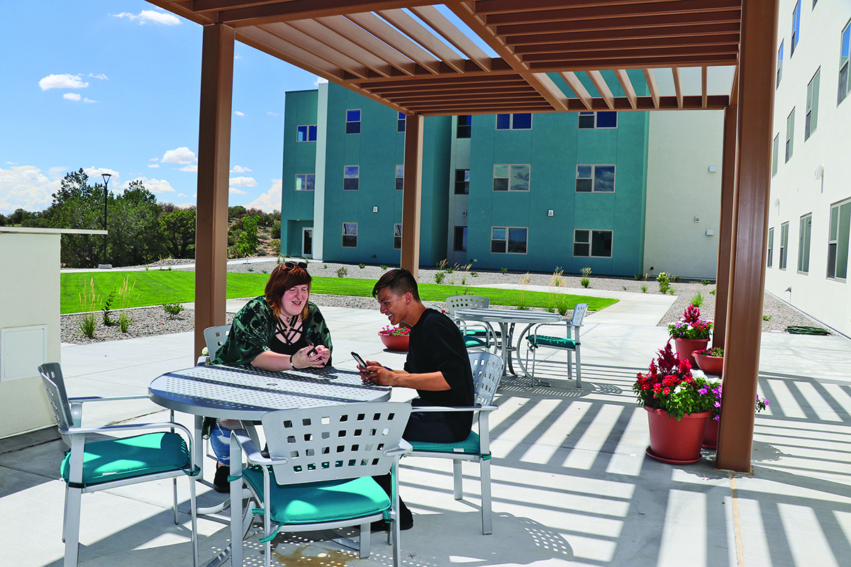 Housing-students in patio area Nizhóní Sunrise Suites