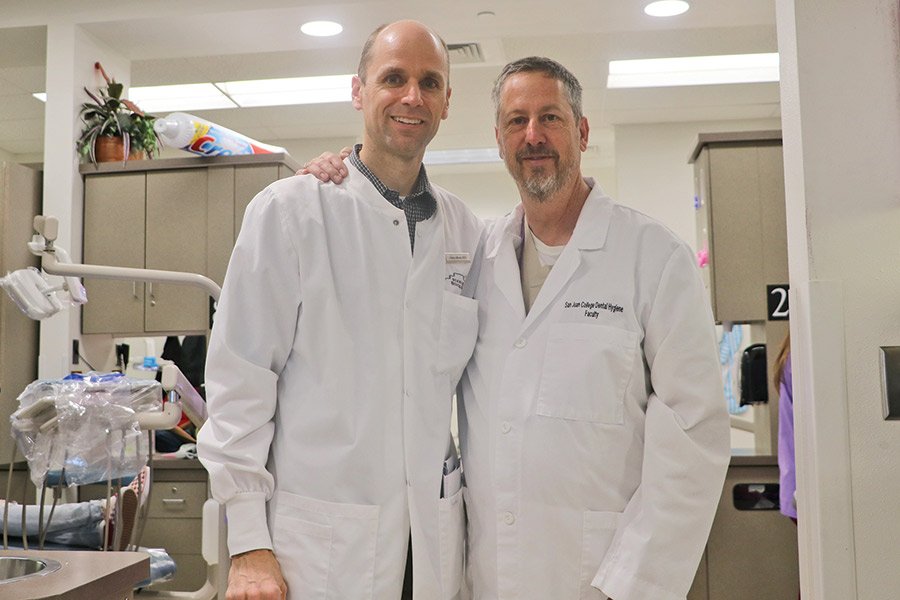 Drs. Gene Hilton and Julius Manz, shown side-by-side in the SJC Dental Clinic, have been working together on the GKAS event for many years.