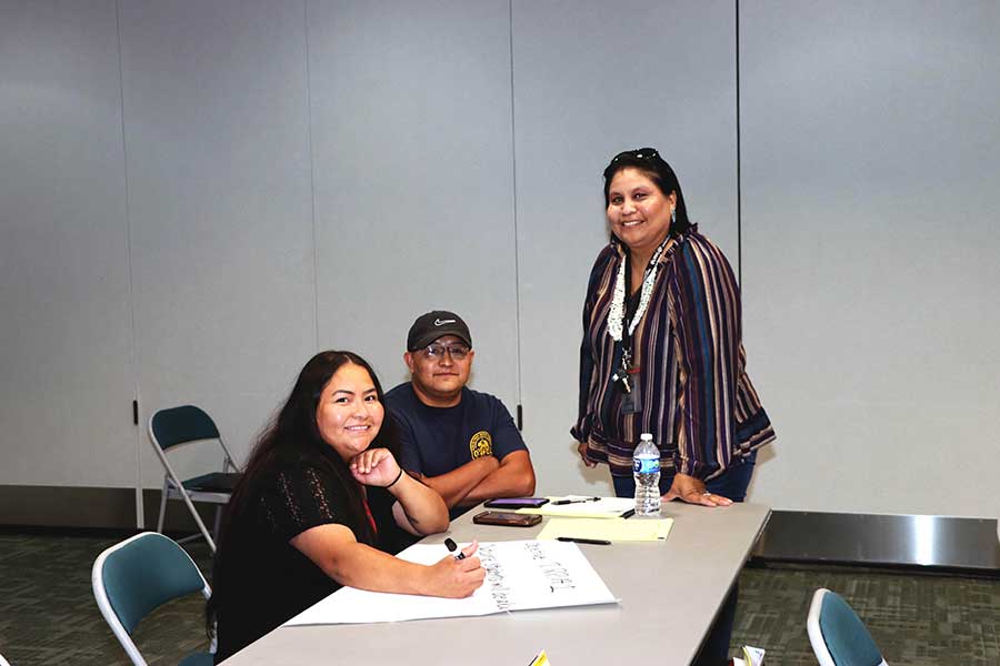 Two SJC students who are enrolled in the TeachUp Academy are meeting with a Western New Mexico Advisor