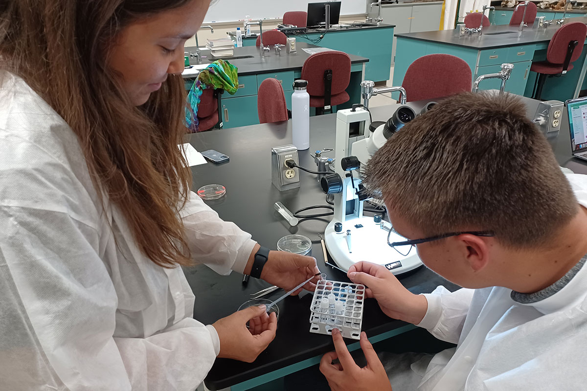 Science students working with samples in lab setting.